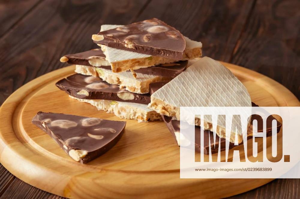 Wedges of turron, Wedges of classic and chocolate turron on wooden background, Wedges of classic and chocolate turron on wooden background, 04.03.2023,