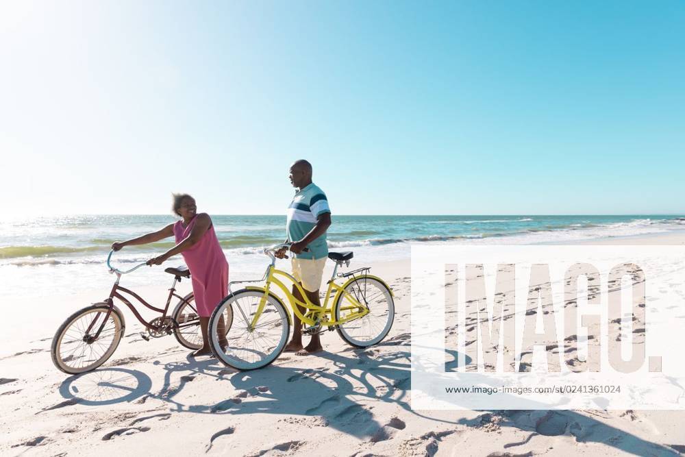 African american senior couple with bikes walking and talking at beach against clear sky in summer African american senior couple with bikes walking and talking at beach against clear sky in summer. Copy space, travel, unaltered, vacation, love, together, retirement, nature, active lifestyle., model released, , property released, Cape Town, South Africa, 19.01.2023, 3932084.jpg, people,african american,senior couple,bike,walking,talking,beach,clear,sky,summer,copy space,space travel,retired,unaltered,vacation,love,together,retirement,nature,sea,landscape,travel,outdoor,water,ocean,beautiful,tourism,blue,coast,holiday,sun,view,sand,green,natural,tropical,outdoors,sunny,day,african,american,senior,couple,copy,space Senior,Elderly,Man,Male,Bl