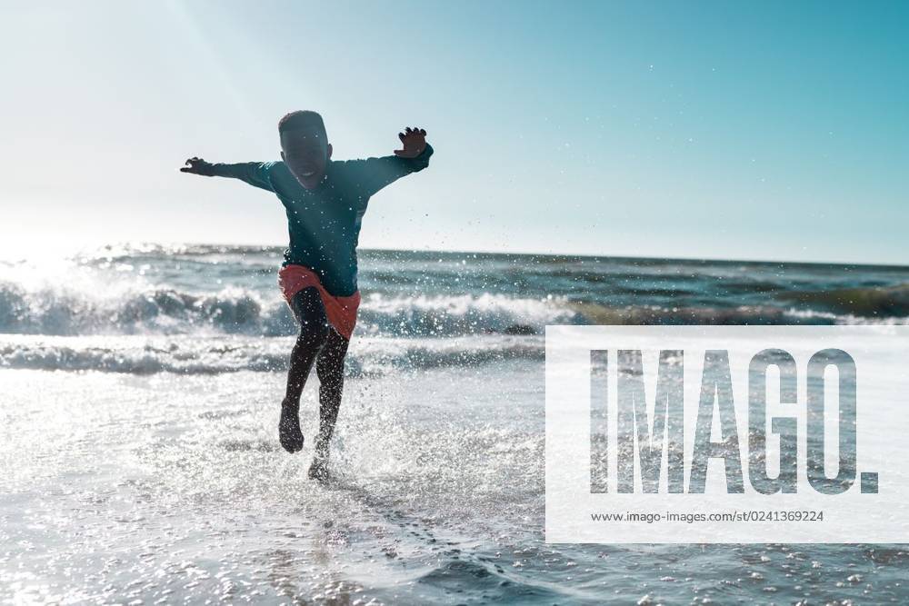 Full length of carefree african american boy running and splashing water in sea against clear sky Full length of carefree african american boy running and splashing water in sea against clear sky. Copy space, unaltered, childhood, nature, vacation, playing, enjoyment and summer concept., model released, , property released, Cape Town, South Africa, 19.01.2023, 3991069.jpg, people,full length,carefree,african american,boy,running,splashing water,sea,clear,sky,copy space,unaltered,childhood,nature,vacation,playing,enjoyment,ocean,summer,water,travel,landscape,beach,tourism,outdoor,blue,beautiful,coast,view,sun,kid,holiday,fun,leisure,tropical,sand,sunny,full,length,african,american,splashing,copy,space Child,Boy,Male,Black