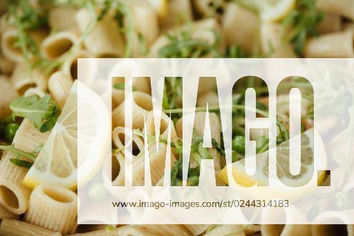 A close-up shot of rigatoni pasta with lemons and greens served on a plate. *** einer schließen Aufwärts erschossen des rigatoni Teigwaren mit Zitronen und Grünen angerichtet am einer Teller 1997150