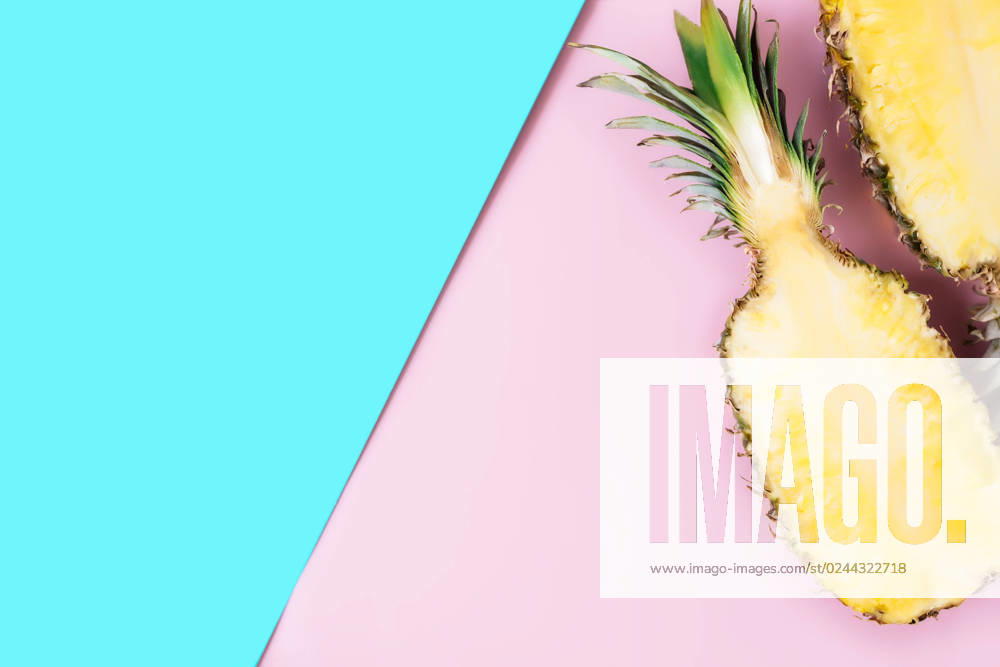 Cut halves of fresh pineapple on pastel pink and blue background. Exotic fruit Flat lay with cut halves of fresh pineapple on a pastel pink and blue background. Ingredient for Pina Colada. Exotic fruit. High quality photo