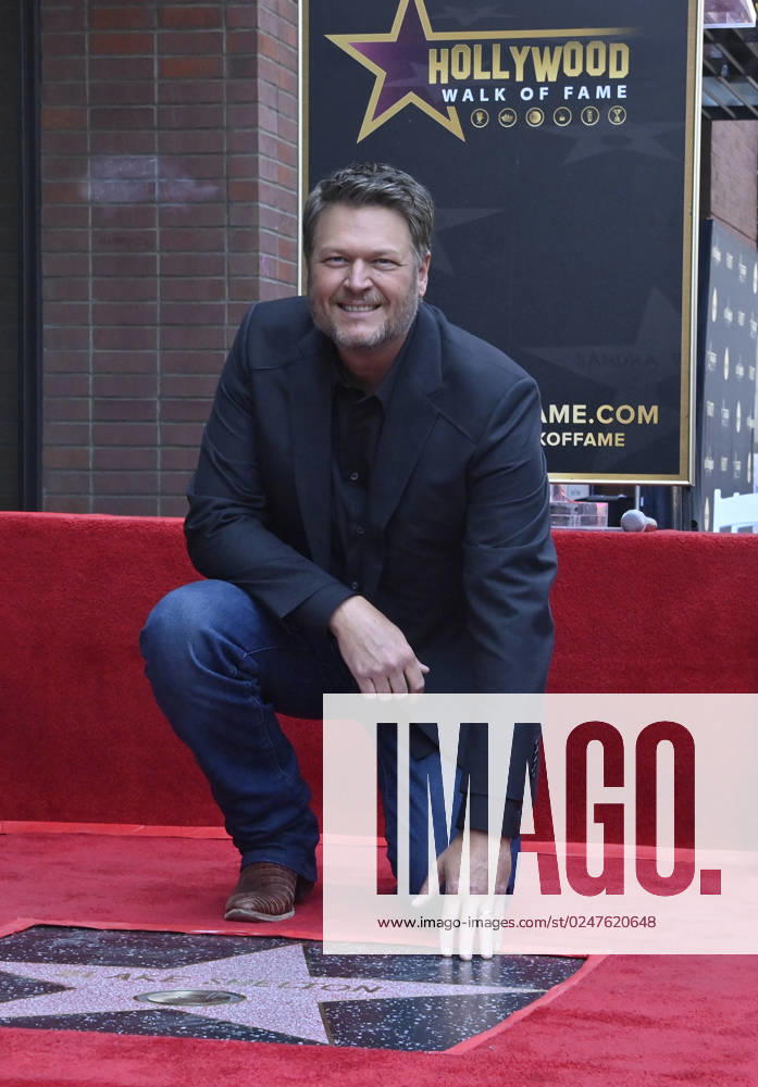 Singer and entertainer Blake Shelton kneels beside his star during an unveiling ceremony honoring him with the 2,755th star on the Hollywood Walk of Fame on Friday, May 12, 2023. LAP2023051211 JIMxRUYMEN