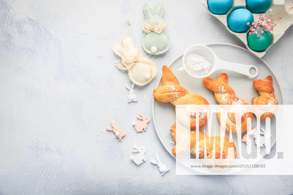 Easter baking - Buns made from yeast dough in a shape of Easter bunny and colored eggs Easter baking - Buns made from yeast dough in a shape of Easter bunny and colored eggs