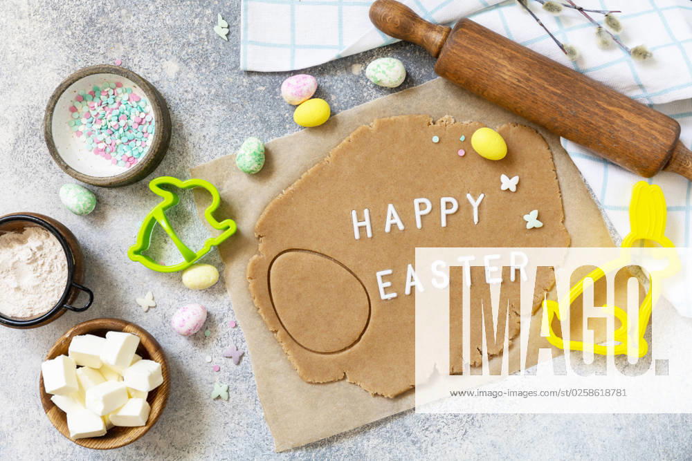 Background for baking or cooking Easter cookies. Ingredients and kitchen utensils for baking on a light stone table. Background for baking or cooking Easter cookies. Ingredients and kitchen utensils for baking on a light stone table.