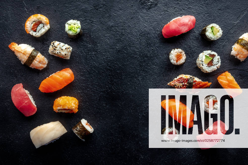 Sushi frame, a flat lay, top shot. Rolls, maki, nigiri on a black background Sushi frame, a flat lay, top shot. Rolls, maki, nigiri on a black slate background, Japanese food. Salmon, eel, shrimp, tuna etc with rice, with a place for text
