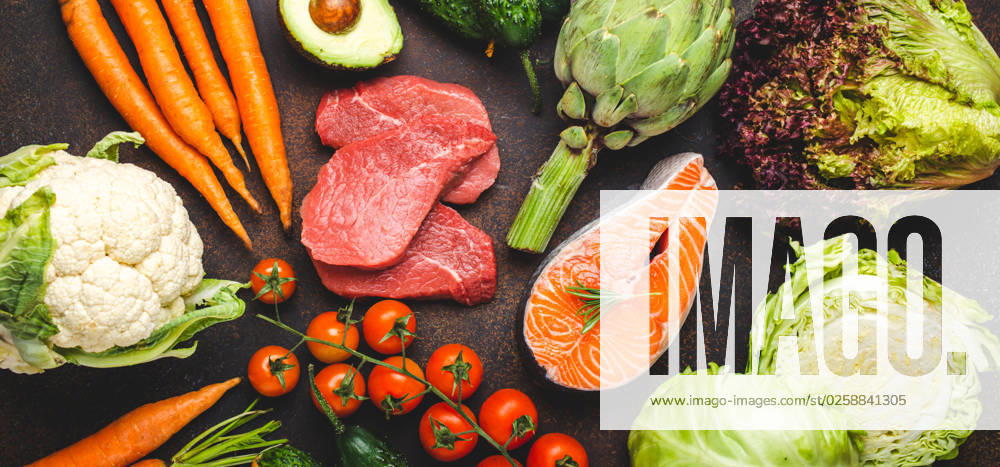 Assorted food raw products: vegetables, beef meat, fish salmon fillet on dark rustic brown stone table top view. Healthy food background, ingredients with vitamins concept, diet and nutrition Assorted food raw products: vegetables, beef meat steak, fish salmon fillet on dark rustic brown stone table top view. Healthy food background, ingredients with vitamins concept, diet and nutrition