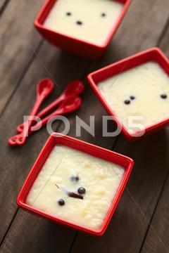 Three red bowls of the ecuadorian dessert called morocho (coarsely ground white corn) cooked with milk, sugar and spices (cinnamon and allspice), similarly to rice pudding (selective focus, focus into the middle of the lower bowl) allspice, bowl, cinnamon, coarse, condiment, cooked, corn, dessert, ecuador, ecuadorian, food, ground, jamaica pepper, kernel, maize, milk, morocho, newspice, porridge, prepared, pudding, red, spice, sweet, traditional, vertical, white, south, latin, america, american, specialty