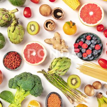 Vegan food. Healthy diet concept. Fruits, vegetables, pasta, nuts, legumes, mushrooms, overhead square shot on a white background. A flatlay composition vegan, vegetarian, food, healthy, diet, white, background, fruit, vegetable, pasta, mushrooms, legumes, pulses, overhead, above, view, top, shot, flat, lay, flat lay, flatlay, table, cooking, kitchen, raw, fresh, nutrition, ingredient, concept, veg, produce, supermarket, organic, vitamin, carbohydrate, fiber, wholesome, natural, superfood, grapefruit, artichoke, broccoli, various, variety, assortment, many, different, pattern, ginger
