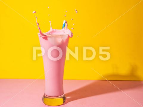 A glass of strawberry smoothie isolated on yellow and pink background fruit, diet, berry, strawberry, drink, healthy, nutrition, food, fresh, blended, vitamin, milkshake, background, summer, smoothie, sweet, dessert, refreshment, juicy, juice, glass, pink, isolated, straw, beverage, horizontal, yellow