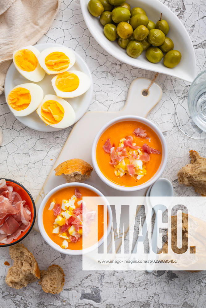 Salmorejo - raw tomato soup with ingredients on a kitchen table Salmorejo - raw tomato soup with ingredients on a kitchen table, spanish cuisine for hot summer