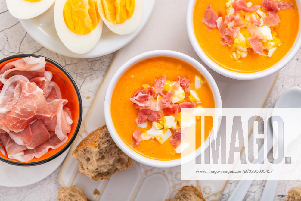 Salmorejo - raw tomato soup with ingredients on a kitchen table Salmorejo - raw tomato soup with ingredients on a kitchen table, spanish cuisine for hot summer