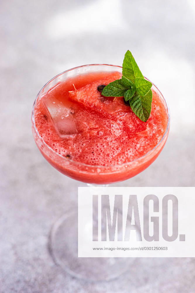 Top view of cup of fresh Margarita cocktail with watermelon smoothie covered with mint leaves Model Released AnnaBogush_ID15921_484856_001