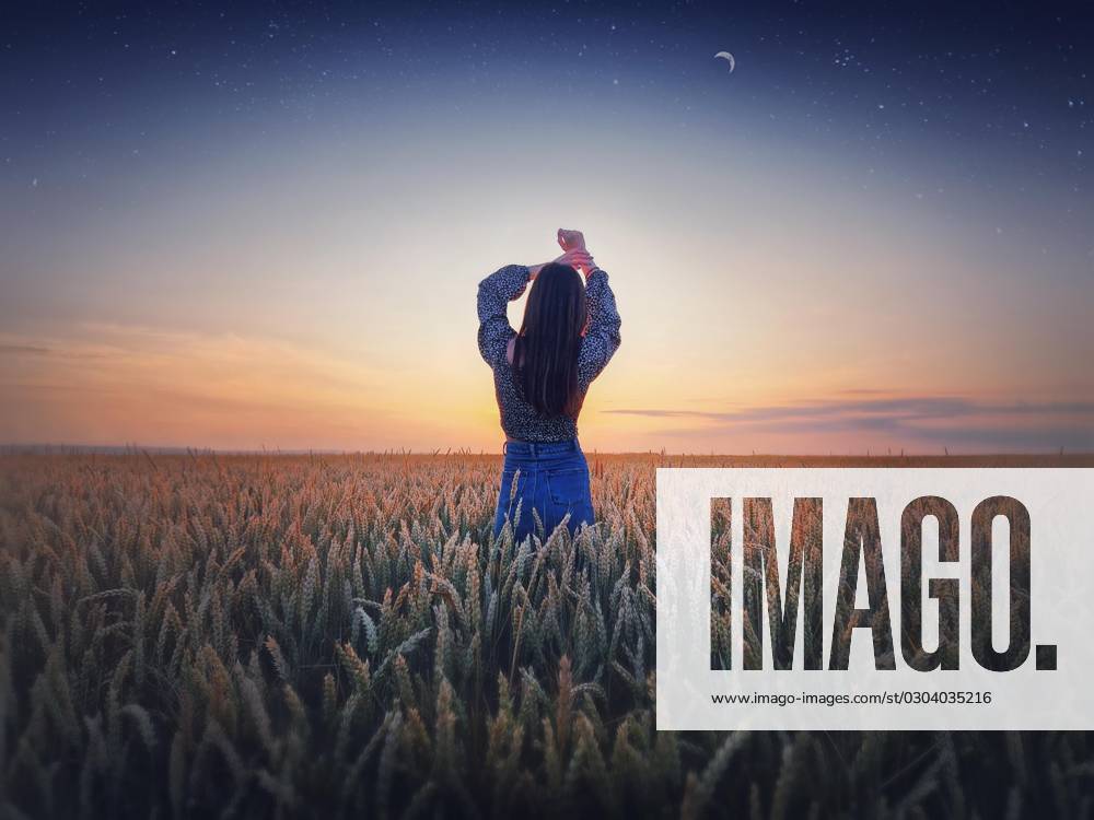 Girls at Golden Wheat field at Sunset Beauty Twilight landscape at the summery Starry sky with Crescent moon magic natural Scene, Freedom Concept