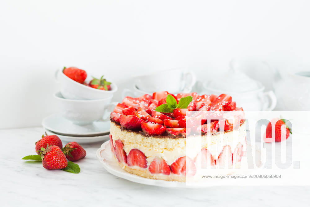 Strawberry cake Fraisier on the white plate and cups Strawberry cake Fraisier on the white plate and cups for teatime, berries and dishware on the background ,model released, Symbolfoto