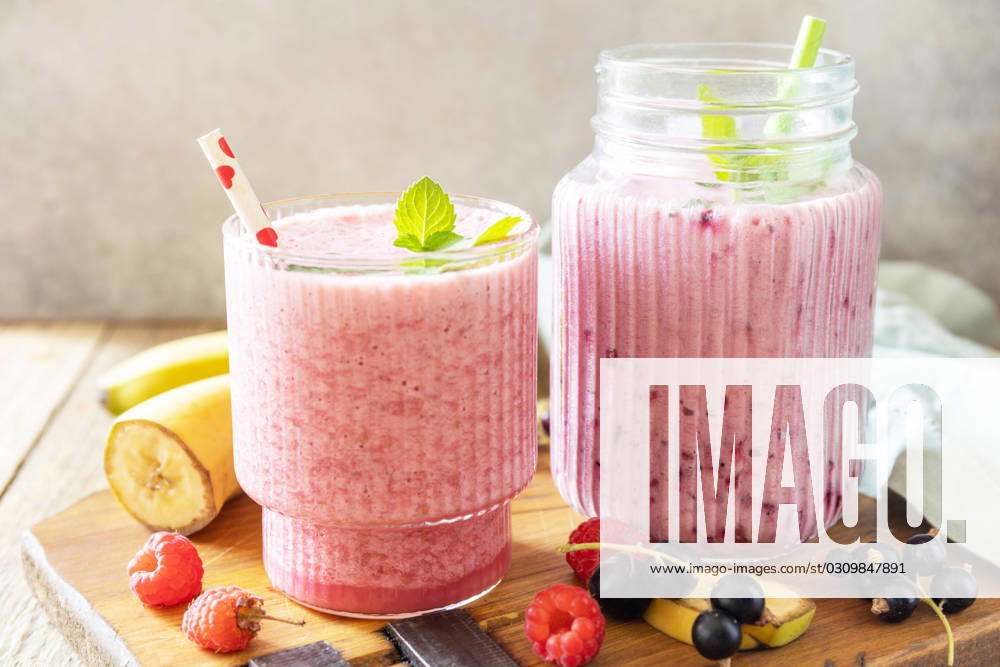 Set of fresh various delicious milkshakes or smoothies with fresh berries on a rustic background. Raspberries and black currant. Set of fresh various delicious milkshakes or smoothies with fresh berries on a rustic background. Raspberries and black currant.