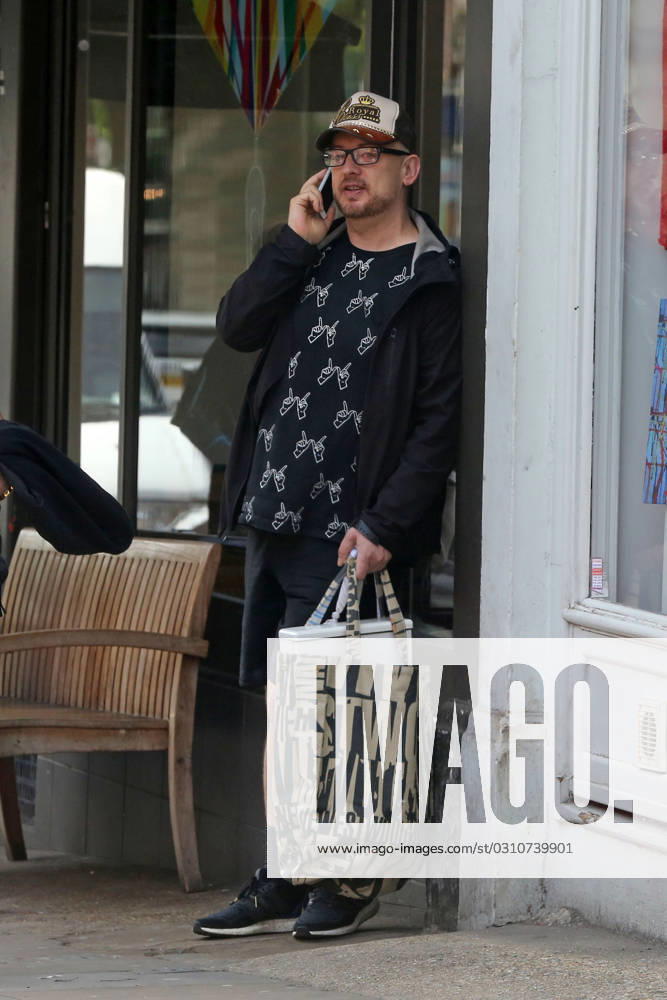 EXCLUSIVE: A dressed down Boy George was spotted having an animated chat on his mobile phone at Starbucks in Hampstead 138100, EXCLUSIVE: A dressed down Boy George was spotted having an animated chat on his mobile phone at Starbucks in Hampstead. The Culture Club singer, wearing a Whatever hand gesture printed shirt, recently revealed that Grammy winning singer Sam Smith was his new neighbor. London, United Kingdom - Tuesday June 2, 2015. UK, FRANCE, GERMANY, ITALY, MAILONLINE OUT, Credit:PacificCoastNews Avalon United Kingdom, London