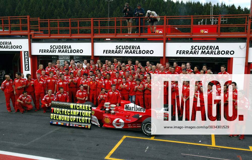 BRU460 - - FRANCORCHAMPS, BELGIUM : The whole Ferrari team pose for a family picture after the Belgian Formula One Grand Prix, Sunday 29 August 2004, on the race track of Spa-Francorchamps. Finnish Kimi Raikkonen won the race and Michael Schumacher got World Champion for the 7th time. MICHELxKRAKOWSKI x2141813x