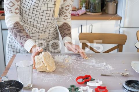 Hands knead thick dough on the kitchen table, decorated with festive decorations for Christmas and New year. Baking at home, aroma and comfort. Close-up knead, thick, dough, kitchen, table, christmas, flour, new year, baking, molds, cookies, snowman, home, aroma, comfort, hands, housewife, bakery, wheat, bread, mood, cozy, interior, decor, preparing, sculpt, woman, cook, homemade, dessert, cutting, form, prepare, making, shape, raw, baker, recipe, kneading, cooking, pastry, sweet, winter, holiday, cookie, bake, eating, hand, cuisine