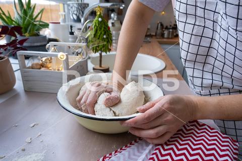 Hands knead thick dough on the kitchen table, decorated with festive decorations for Christmas and New year. Baking at home, aroma and comfort. Close-up knead, thick, dough, kitchen, table, Christmas, New year, Baking, home, aroma, comfort, Close up, Hands, flour, cookies, housewife, pizza, wheat, bread, mood, cozy, interior, decor, preparing, sculpt, woman, cook, lifestyle, dessert, cutting, form, prepare, knead, making, shape, raw, baker, recipe, kneading, cooking, pastry, sweet, winter, holiday, cookie, bake, preparation, bakery, homemade, food