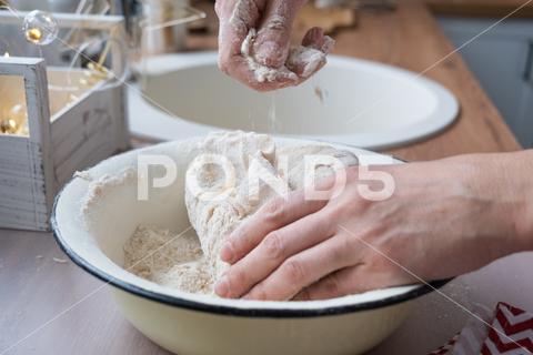 Hands knead thick dough on the kitchen table, decorated with festive decorations for Christmas and New year. Baking at home, aroma and comfort. Close-up knead, thick, dough, kitchen, table, Christmas, New year, Baking, home, aroma, comfort, Close up, Hands, flour, cookies, housewife, pizza, wheat, bread, mood, cozy, interior, decor, preparing, sculpt, woman, cook, lifestyle, dessert, cutting, form, prepare, knead, making, shape, raw, baker, recipe, kneading, cooking, pastry, sweet, winter, holiday, cookie, bake, preparation, bakery, homemade, food