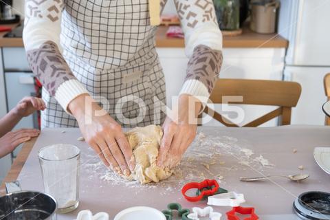 Hands knead thick dough on the kitchen table, decorated with festive decorations for Christmas and New year. Baking at home, aroma and comfort. Close-up knead, thick, dough, kitchen, table, christmas, flour, new year, baking, molds, cookies, snowman, home, aroma, comfort, hands, housewife, bakery, wheat, bread, mood, cozy, interior, decor, preparing, sculpt, woman, cook, homemade, dessert, cutting, form, prepare, making, shape, raw, baker, recipe, kneading, cooking, pastry, sweet, winter, holiday, cookie, bake, eating, hand, cuisine