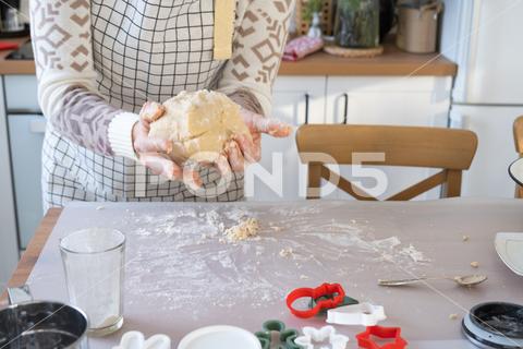 Hands knead thick dough on the kitchen table, decorated with festive decorations for Christmas and New year. Baking at home, aroma and comfort. Close-up knead, thick, dough, kitchen, table, christmas, flour, new year, baking, molds, cookies, snowman, home, aroma, comfort, hands, housewife, bakery, wheat, bread, mood, cozy, interior, decor, preparing, sculpt, woman, cook, homemade, dessert, cutting, form, prepare, making, shape, raw, baker, recipe, kneading, cooking, pastry, sweet, winter, holiday, cookie, bake, eating, hand, cuisine