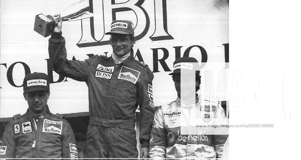 MONZA ---- NIKI LAUDA OF AUSTRIA (C) RAISES HIS CUP AFTER WINNING THE 55TH GRAND PRIX OF ITALY 09 09 84 . AT RIGHT ITALY S RICCARDO PATRESE , 3 RD, AND AT LEFT ITALY S MICHELE ALBORETO, 2ND PLACED. .JEP WST BELGA. x85105218stx