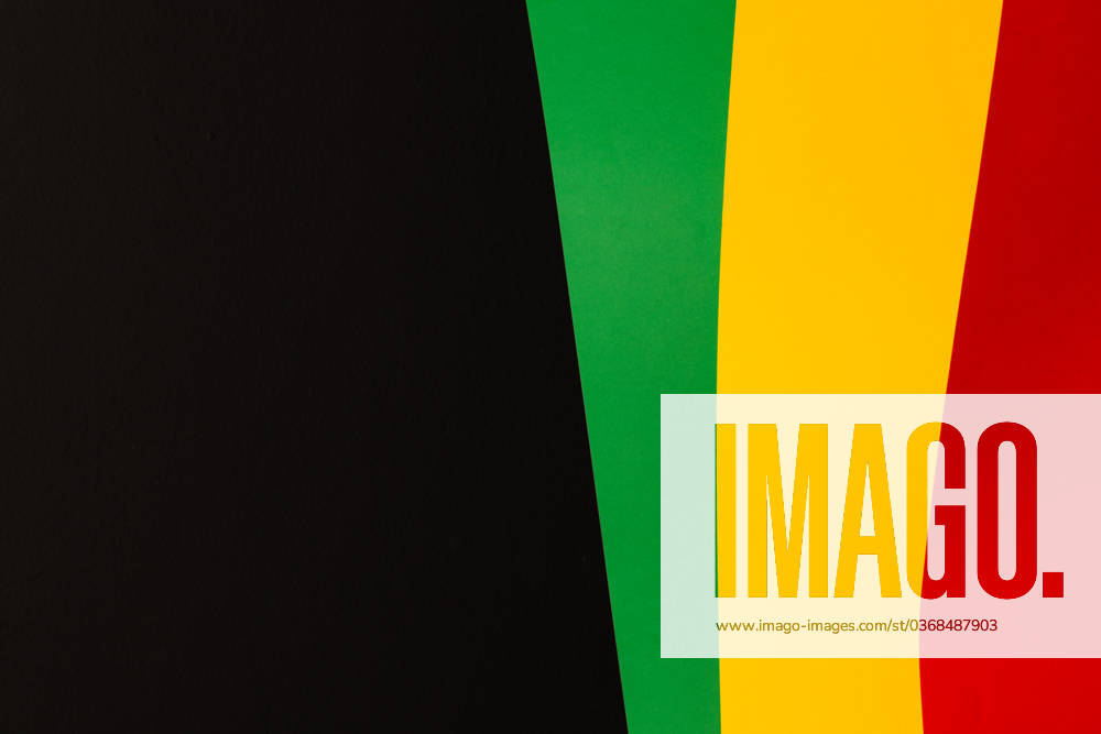 Green, yellow and red papers with copy space on black background. Black history month, africa, black culture and history concept.