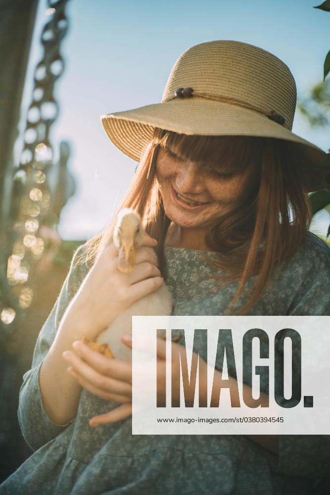 Smiling young woman with freckles holding duckling model released, Symbolfoto property released, ADF00194