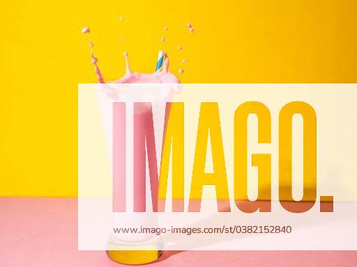 A glass of strawberry smoothie isolated on yellow and pink background 1043357 RECORD DATE NOT STATED