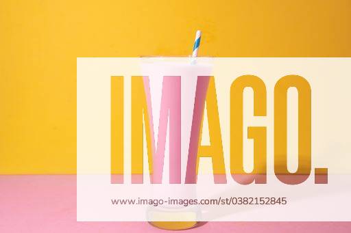A glass of strawberry smoothie isolated on yellow and pink background 1043359 RECORD DATE NOT STATED