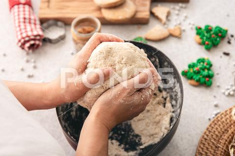 Hands knead thick dough on the kitchen table, decorated with festive decorations for Christmas and New year, baking at home. christmas food pastry dough homemade flour hand cooking gingerbread baking traditional kitchen table woman holiday xmas cookie sweet sugar bake cook home cake dessert biscuit delicious bowl celebration domestic person kneading lifestyle handmade fresh tasty recipe natural organic nutrition baked ingredient bakery chef dish preparation culinary festive