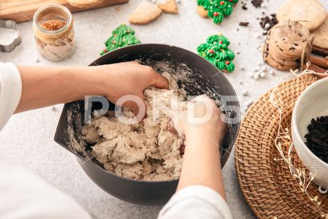 Hands knead thick dough on the kitchen table, decorated with festive decorations for Christmas and New year, baking at home. christmas food pastry dough homemade flour hand cooking gingerbread baking traditional kitchen table woman holiday xmas cookie sweet sugar bake cook home season cake dessert snack biscuit delicious bowl background celebration domestic person kneading cinnamon rolling lifestyle handmade fresh tasty recipe breakfast natural organic nutrition baked ingredient