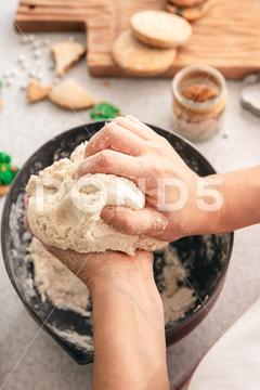 Hands knead thick dough on the kitchen table, decorated with festive decorations for Christmas and New year, baking at home. christmas food pastry dough homemade flour hand cooking gingerbread baking traditional kitchen table woman holiday xmas cookie sweet sugar bake cook home cake dessert biscuit delicious bowl celebration domestic person kneading lifestyle handmade fresh tasty recipe natural organic nutrition baked ingredient bakery chef dish preparation culinary festive