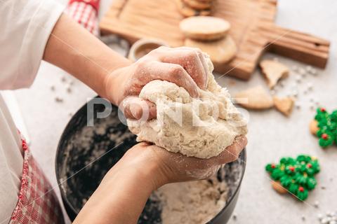 Hands knead thick dough on the kitchen table, decorated with festive decorations for Christmas and New year, baking at home. christmas food pastry dough homemade flour hand cooking gingerbread baking traditional kitchen table woman holiday xmas cookie sweet sugar bake cook home cake dessert biscuit delicious bowl celebration domestic person kneading lifestyle handmade fresh tasty recipe natural organic nutrition baked ingredient bakery chef dish preparation culinary festive