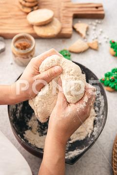 Hands knead thick dough on the kitchen table, decorated with festive decorations for Christmas and New year, baking at home. christmas food pastry dough homemade flour hand cooking gingerbread baking traditional kitchen table woman holiday xmas cookie sweet sugar bake cook home cake dessert biscuit delicious bowl celebration domestic person kneading lifestyle handmade fresh tasty recipe natural organic nutrition baked ingredient bakery chef dish preparation culinary festive