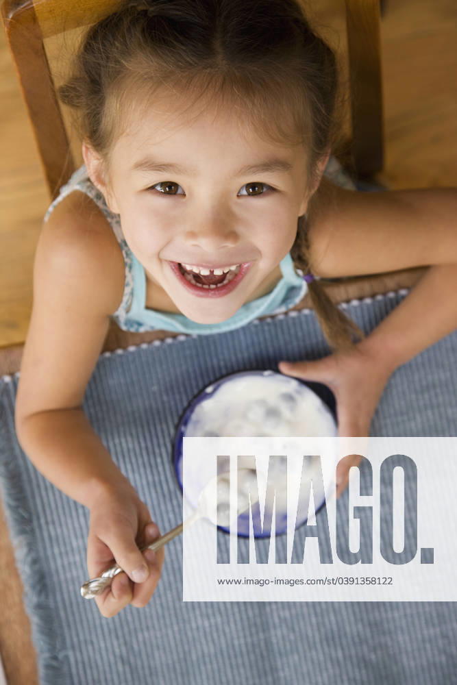 Mixed race young girl eating yogurt with spoon Seattle, WA, 21.12.2023, model released, TTBB_BLD068150.jpg, 4-5 years, anticipation, asian ethnicity, blueberry, bowl, breakfast, caucasian, childhood, close up, color image, directly above, domestic life, eating, elementary age, enjoying, food and drink, girl, grinning, happy, head and shoulders, healthy eating, high angle view, holding, hungry, indoors, japanese ethnicity, lifestyle, looking at camera, looking up, mixed race person, nourishing, nutrition, one girl only, one person, people, photography, portrait, sitting, smiling, snack, snacking, spoon, table, vertical, wholesome, yogurt, minority, minoritiesappreciating, asian, bliss, cheerful, child, children, close-up, closeup, color, co