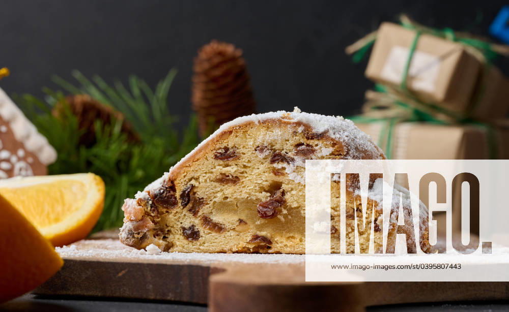 Christmas pastries stollen sprinkled with powdered sugar on the table, festive dessert Christmas pastries stollen sprinkled with powdered sugar on the table, festive dessert