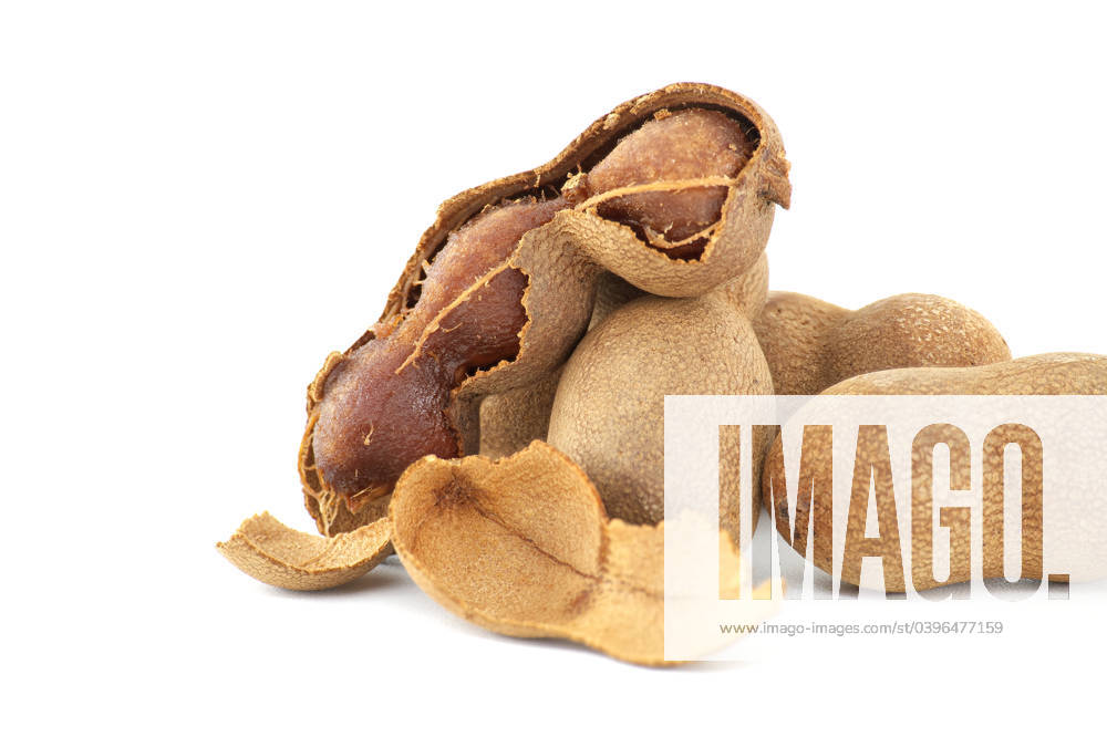Tamarind whole and cracked open on white background Tamarind fruits, whole and cracked open isolated on white background (Tamarindus indica)