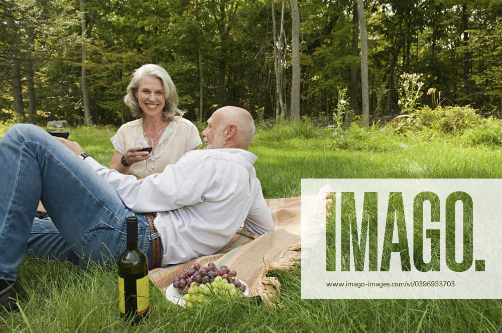 Older couple relaxing at picnic in park Accord, New York, USA, 21.12.2023, model released, TTBB_BLD170599.jpg, 55-59 years, 65-69 years, accord, aging, authentic, authenticity, beauty in nature, bonding, boyfriend, calm, caucasian, color image, copy space, day, drinking, eating, enjoying, environment, focus on foreground, foliage, food and drink, forest, fun, getting away from it all, girlfriend, grape, grass, happy, heterosexual couple, horizontal, husband, lawn, leisure activity, lifestyle, looking at camera, love, man, mature adult, mature women, nature, new york, older, outdoors, park, peace, people, photography, picnic, picnic blanket, portrait, posing, quality time, real people, recreation, relaxation, retirement, romance, rural scen