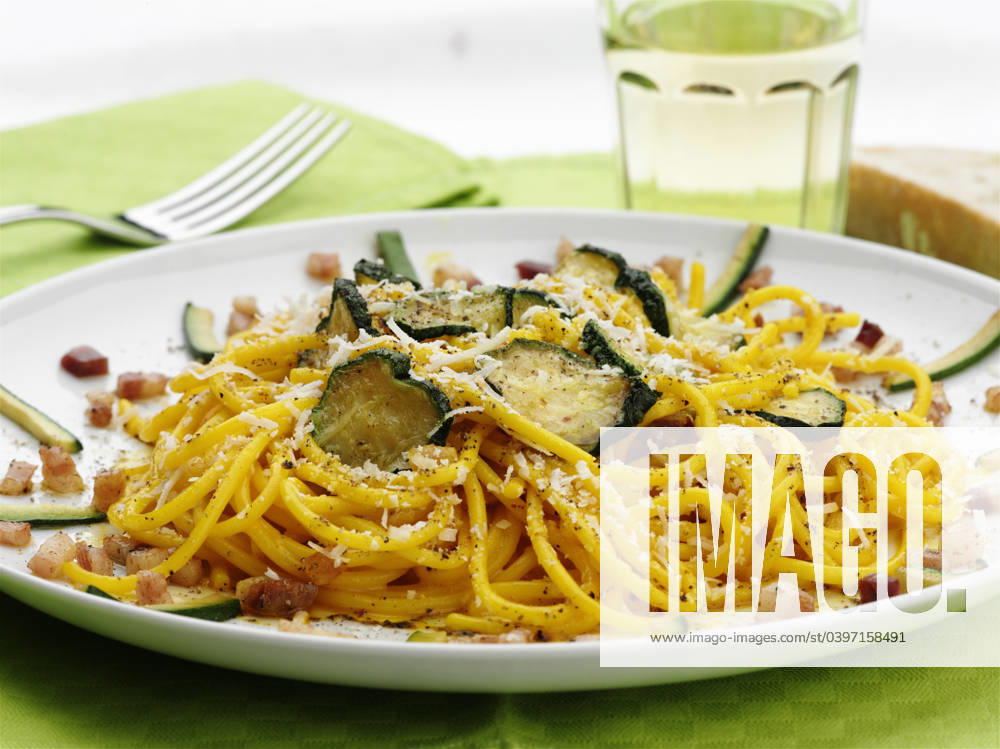 Close up of pasta with zucchini and cheese Milan, Lombardy Metro City of Milan, Italy, 21.12.2023, TTBB_BLD185624.jpg, bacon bit, cheese, close up, color image, focus on foreground, food and drink, horizontal, nobody, pasta, photography, spaghetti, spaghetti alla carbonara con zucchine, still life, studio shot, white background, zucchini, carbohydrate, close-up, closeup, color, colour, courgette, dairy, food, gourd, italian, squash, still-life, studio, vegetable,