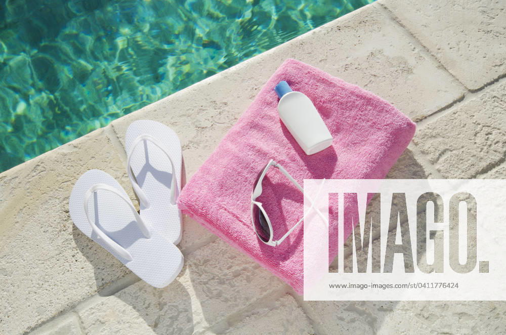 Sandals and towel at poolside , 08.12.2011, TTBB_ti0027_00662.jpg, Day, Leisure, Swimming Pool, Towel, Summer, Outdoors, Relaxation, Horizontal, Vacations, High Angle View, Sandal, Waters Edge, Lotion, Pink, No People