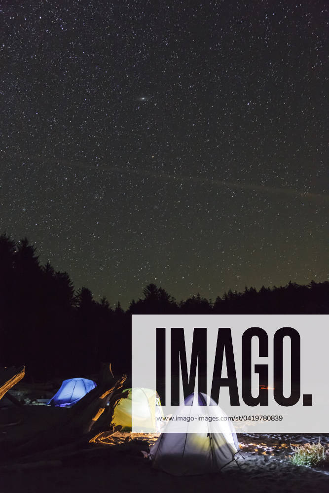 Three tents under the night sky on Vargas Island off the west coast of Vancouver Island British Columbia, Canada.