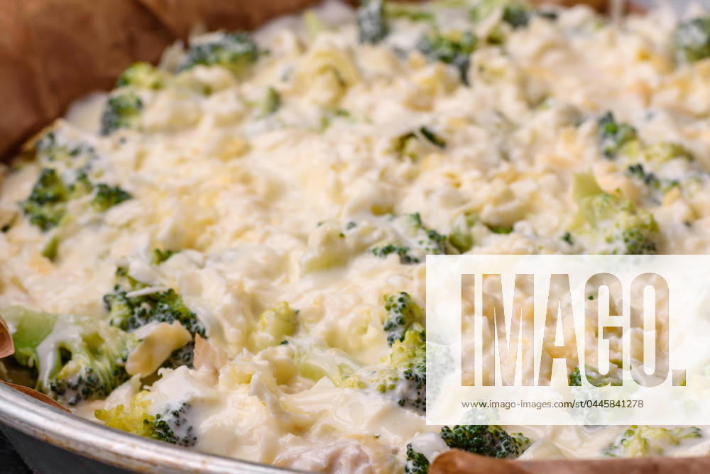 Delicious quiche with broccoli, cheese, chicken, spices and herbs Delicious quiche with broccoli, cheese, chicken, spices and herbs on a dark concrete background