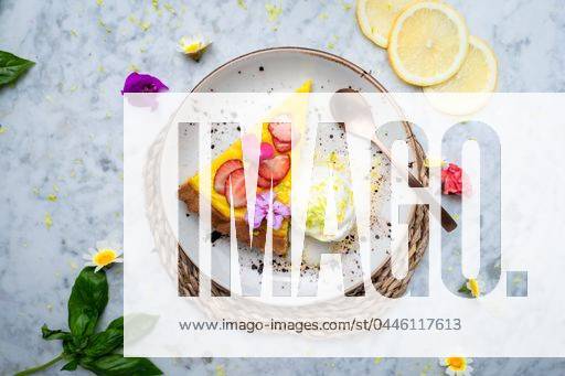 A plate with Vegan No-bake cheesecake topped with strawberry on the side cashew cream. Served on a plate with fruits around. 23149080 RECORD DATE NOT STATED