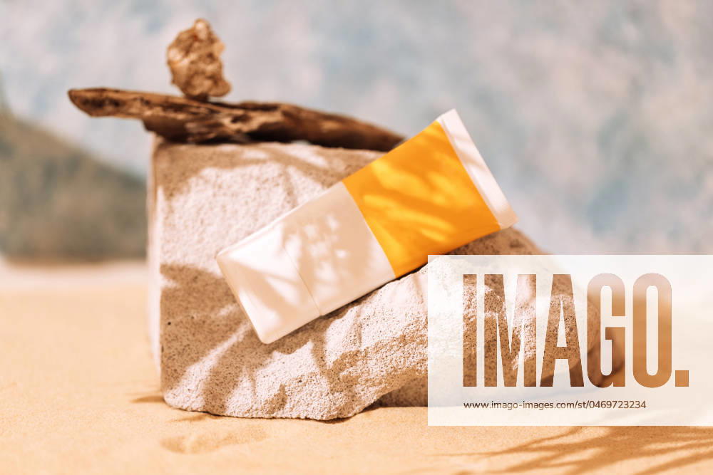 Mockup tubes with sunscreen on textured stones with a tree root Mockup tubes with sunscreen on textured stones with a tree root. A podium for cosmetic products with a layout of an empty bottle on the sand. Sunlight and shade from a palm leaf. ,model released, Symbolfoto