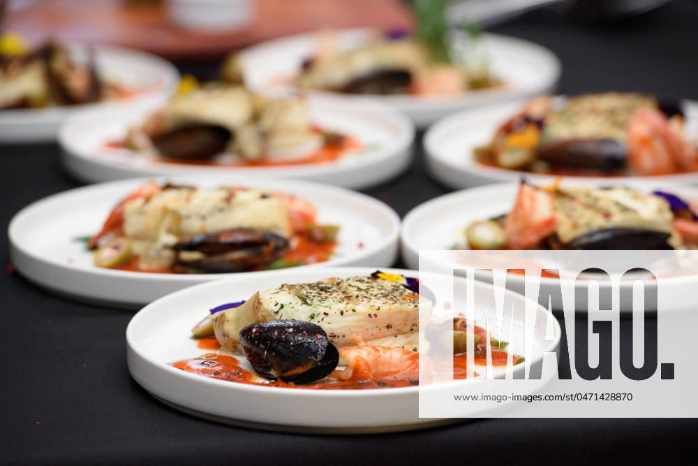 Saganaki, traditional Greek cheese snack that is fried in a pan or grilled saganaki, traditional Greek cheese snack that is fried in a pan or grilled. halloumi cheese with shrimp and mussels. micro green topping
