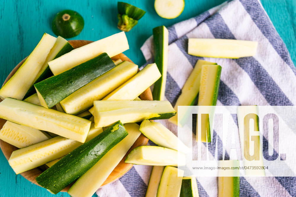 Fresh zucchini sticks prepped on vibrant teal background! Sacramento, California, United States R_OCZQ240507B2-1420340-01