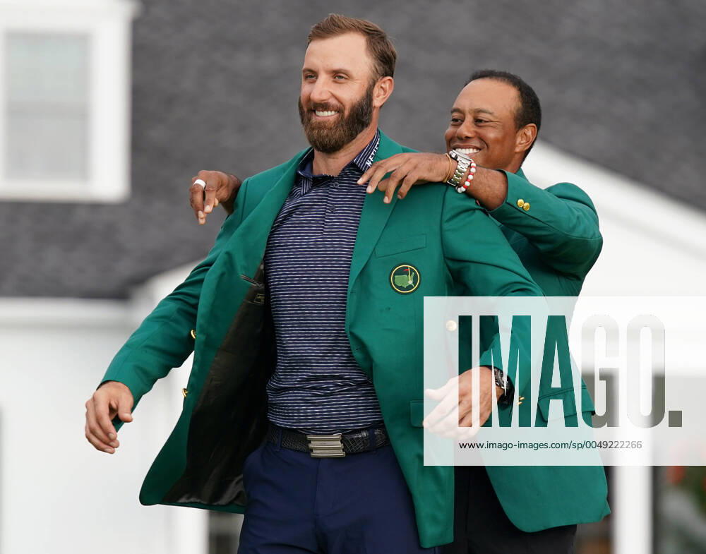 KW46 2019 Masters Champion Tiger Woods puts the Green Jacket on 2020 champion Dustin Johnson after the final round of the 2020 Masters golf tournament at Augusta National Golf Club in Augusta, Georgia on Sunday, November 15, 2020. Dustin Johnson wins the 2020 Masters with a record score of 20 under par. AUG20201115702 KevinxDietsch