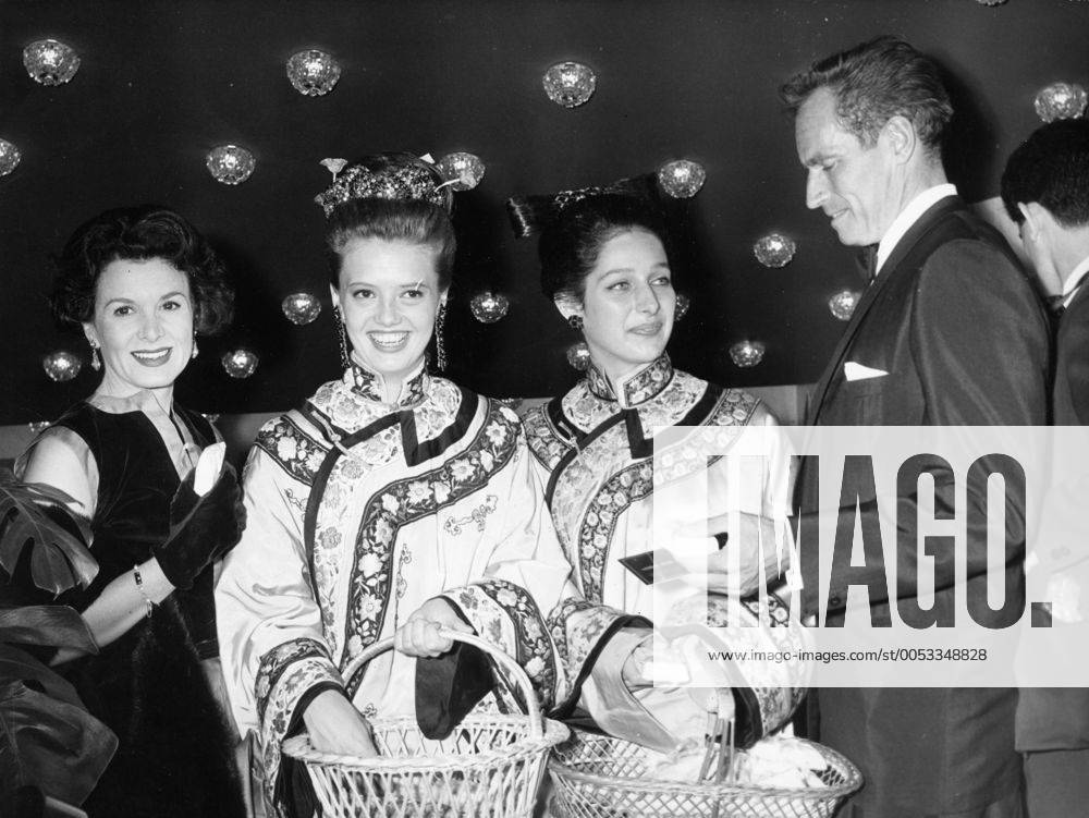 Paris, France; Actor CHARLTON HESTON known for his religious roles in Ben-Hur and The Ten Commandments , pictured with his wife LYDIA CLARKE and Chinese dressed hostesses at the premiere of, 55 Days at Peking . Paris France - ZUMAk09